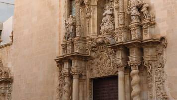 A building facade with intricate stone carvings and a large wooden door.