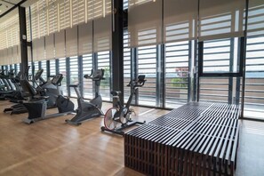 A gym with cardio machines and large windows. - Paxtonz Leisure Suites Kuala Lumpur (Petaling Jaya)