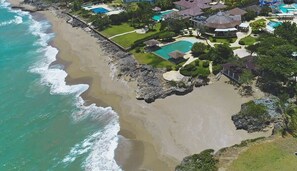 An aerial view of a coastal property with a beach, a swimming pool, and a small pavilion. - Private Pool Oasis in Sosúa Ocean Village (Sosúa)