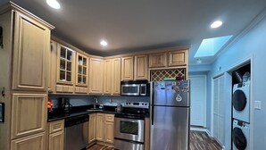 A kitchen with wooden cabinets, stainless steel appliances, and a built-in oven.