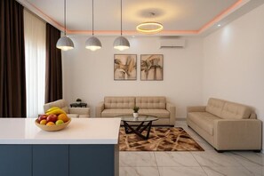 A modern living room with a sofa, coffee table, and fruit bowl. - 2-bedroom apartment in delightful Dakar with fitness room, AC (Dakar)