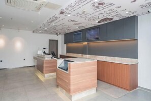 A modern kitchen with a central island, built-in appliances, and a dark upper counter. - HanTing Hotel (Shanghai Hongqiao Railway Station) (Shanghai)