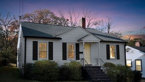 A two-story house with a front porch, a chimney, and a number '18' on the door.
