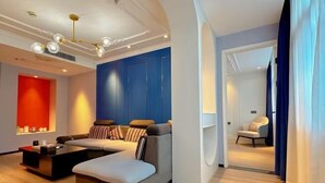 A modern living room with a sofa, coffee table, and a blue accent wall.
