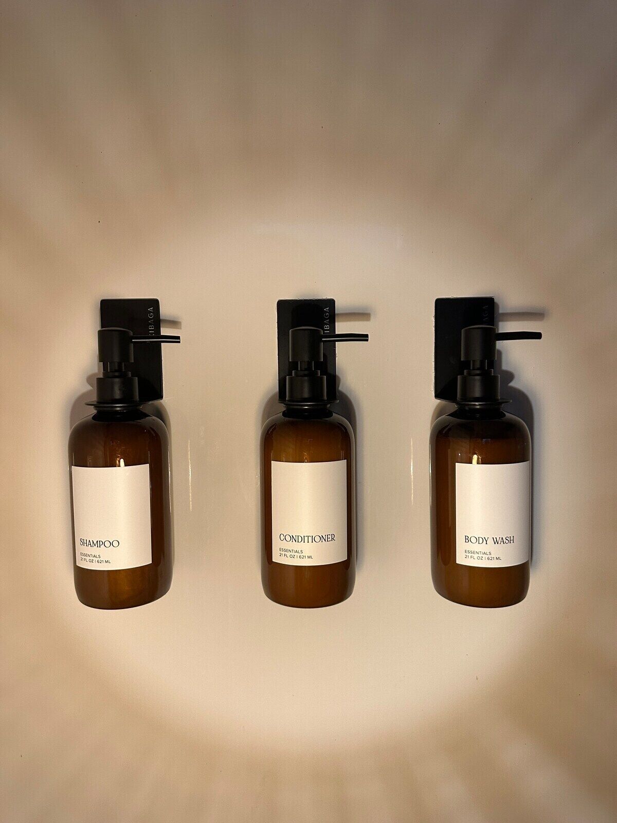 Three bottles of hair care products against a plain background.