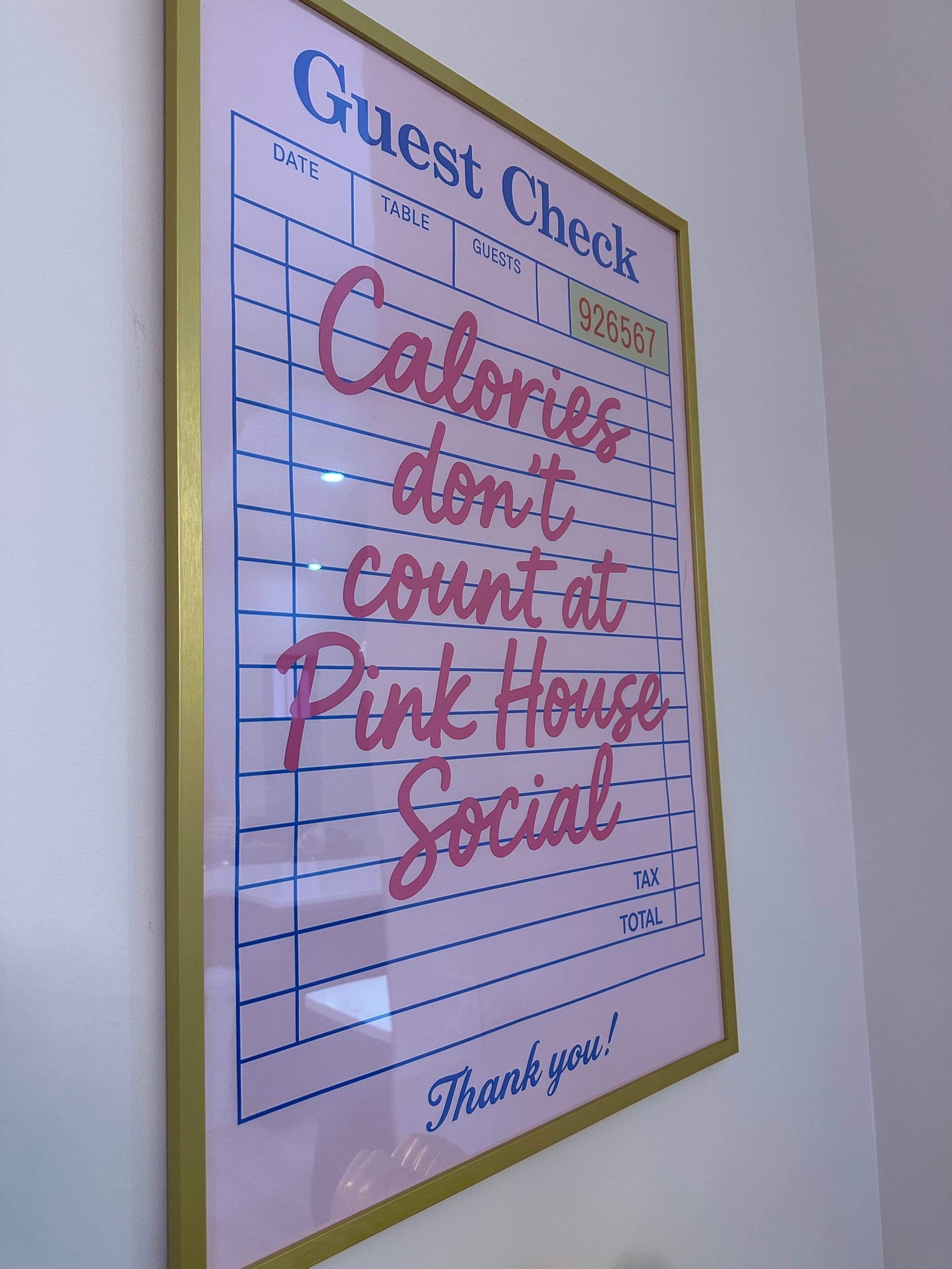 A framed guest check with a message about calories and a thank you note.