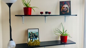 Two black shelves with red pots and a framed photo on the lower shelf. - Traditional Family Home, Driveway & Gardens -  Preston, Samlesbury, M6, M55,M61, (Preston)