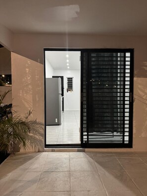 A modern interior with a sliding glass door leading to a hallway. - Fun Stay Curaçao
5 Min to Mambo Beach 2BR Home (Willemstad)