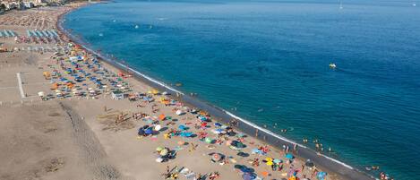 On the beach, sun-loungers, beach towels