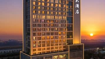 A high-rise hotel with multiple floors, large windows, and a prominent entrance.