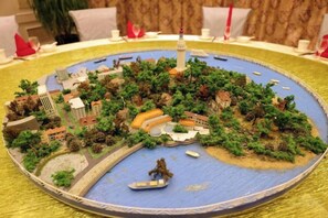 A detailed model of a cityscape with a prominent tower, bridges, and a body of water. - Jinhai Hotel (Yantai Railway Station Wuyue Plaza) (Yantai)