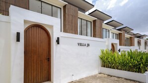 A modern villa with a large wooden door, a white exterior, and a nameplate reading "VILLA JB". - Villa JB Canggu (Canggu)