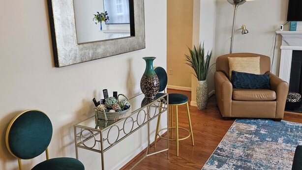 A living room with a sofa, two chairs, a coffee table, a floor lamp, and a fireplace. - PriMary EVolution Properties ~ Atlanta - convenient, comfy, chic 3 bedroom home  (Atlanta)