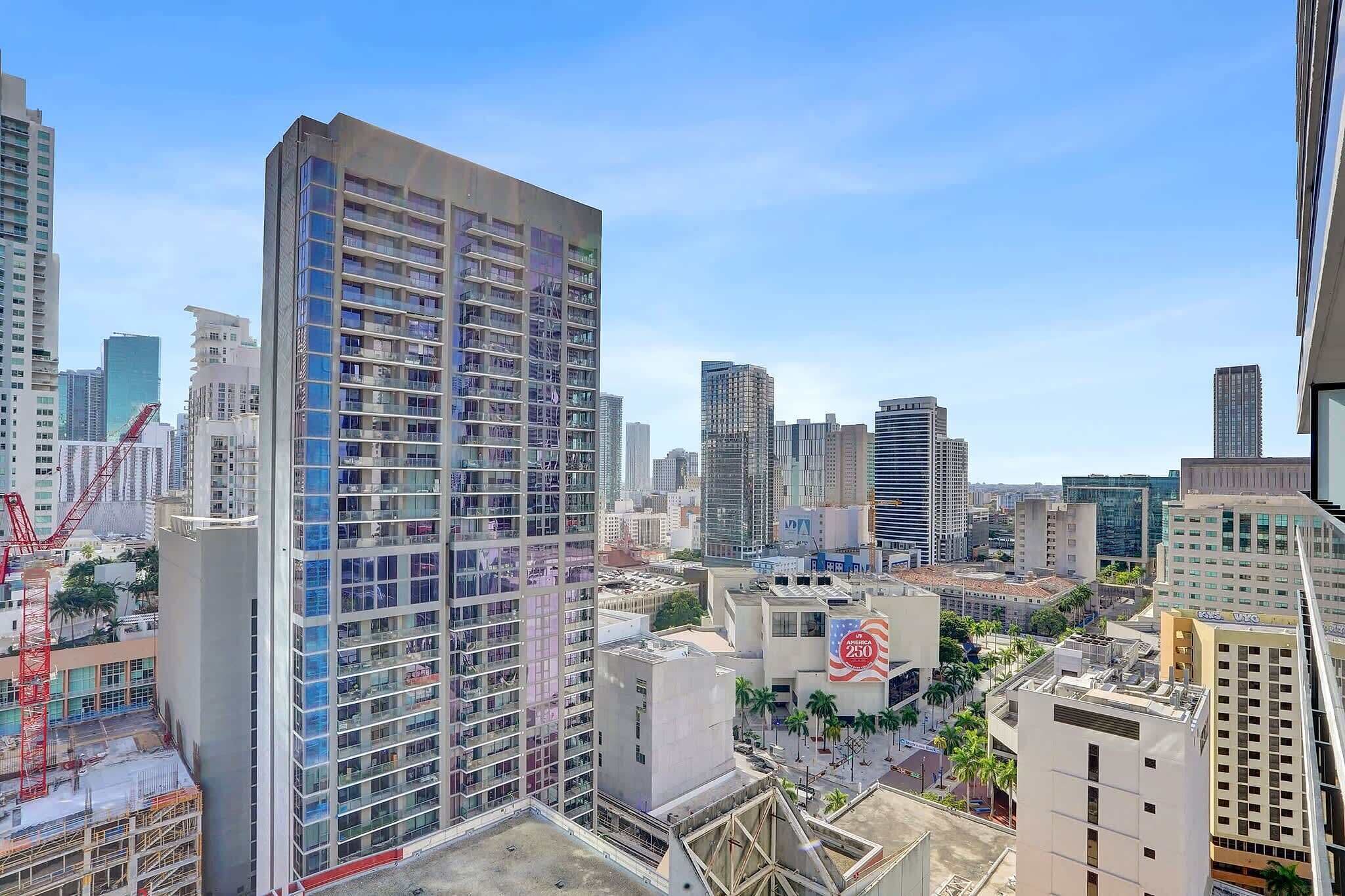 A high-rise building with multiple floors, surrounded by other tall buildings in an urban setting.