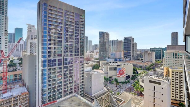 A high-rise building with multiple floors, surrounded by other tall buildings in an urban setting. - Bay View Studio | Rooftop Pool, Downtown Miami (Miami)