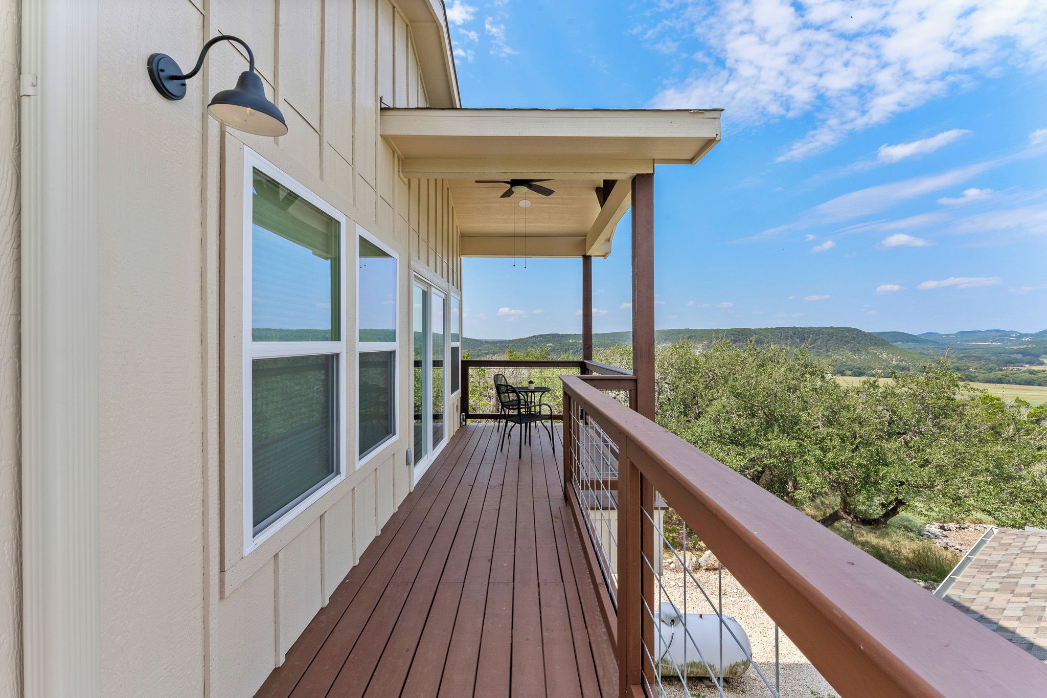 A wooden deck with a view of a mountainous landscape.