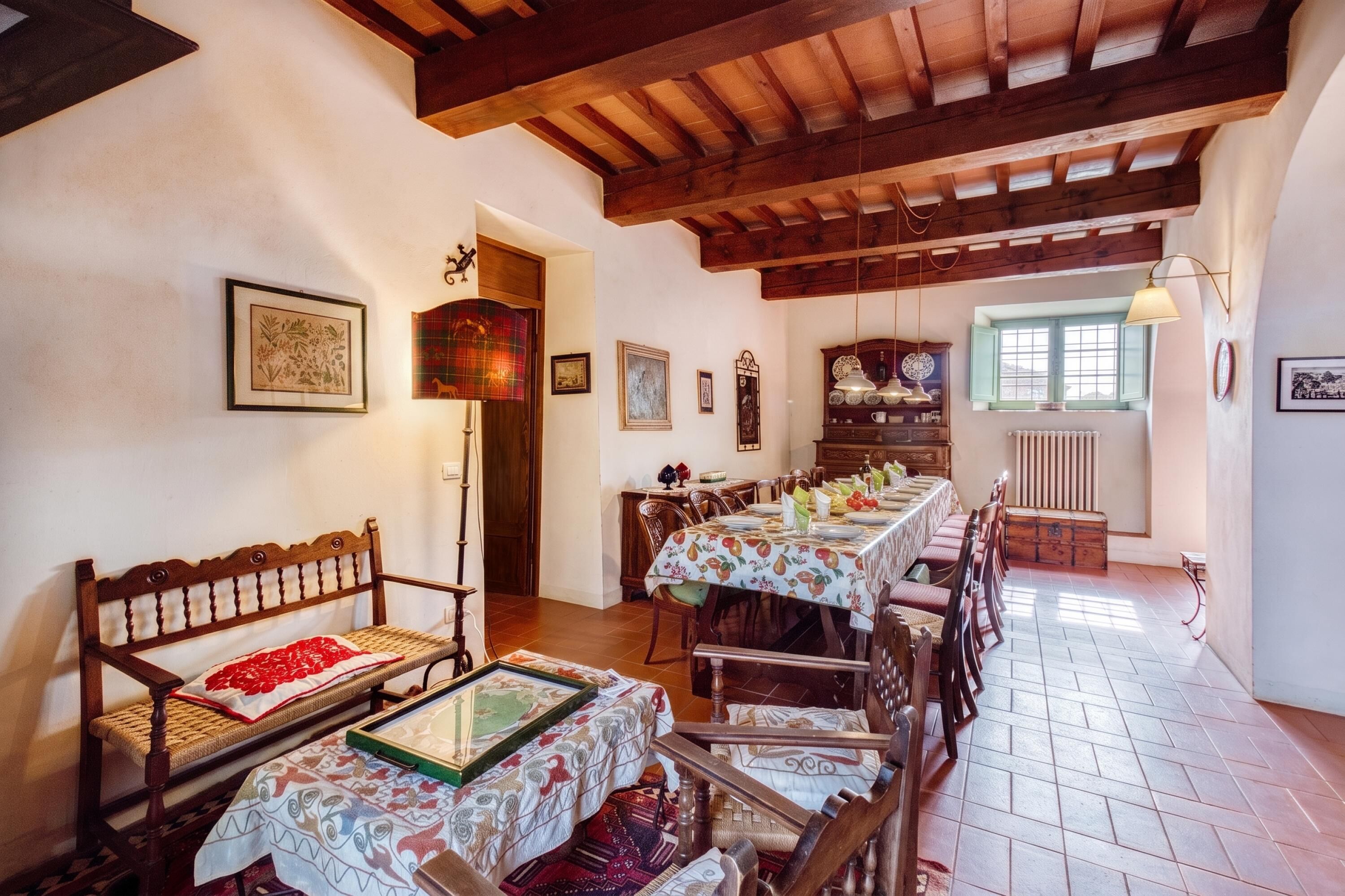 A dining area with a long table, wooden chairs, and a bench.