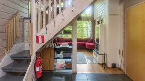Eine Treppe führt zu einem Wohnbereich mit einer Couch, einem Kamin und einem Feuerlöscher.