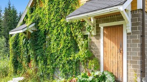 A house with a brick exterior, a wooden door, and a covered porch area. - Vacation home Muhola by Interhome (Enonkoski)