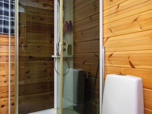 A wooden cabin with a glass-enclosed shower area. - Susiranta by Interhome (Puumala)