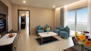 A modern living room with a sofa set, a coffee table, and a dining area. - Le Crown Hotel (Vagamon)