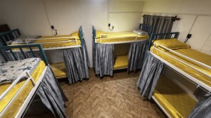 A dormitory room with bunk beds, a desk, and a chair. - Garden Aroma Palolem Beach (Canacona)