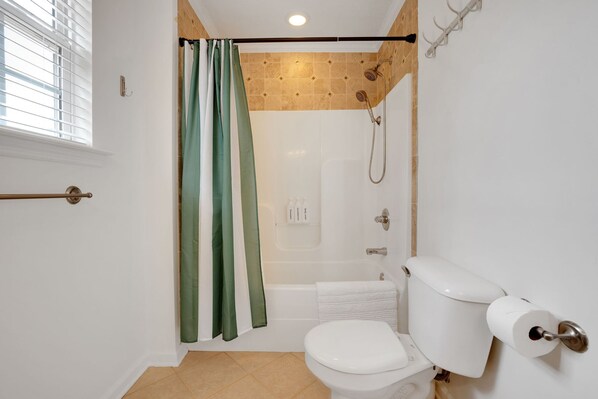 A bathroom with a shower, toilet, and a towel rack. - Augusta Getaway Near Masters Porch Swing Deck (Augusta)