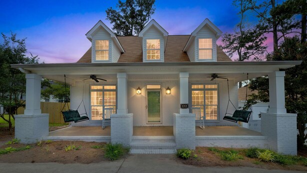 A two-story house with a porch, two swings, and a front door. - Augusta Getaway Near Masters Porch Swing Deck (Augusta)