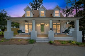 A two-story house with a porch, two swings, and a front door. - Augusta Getaway Near Masters Porch Swing Deck (Augusta)