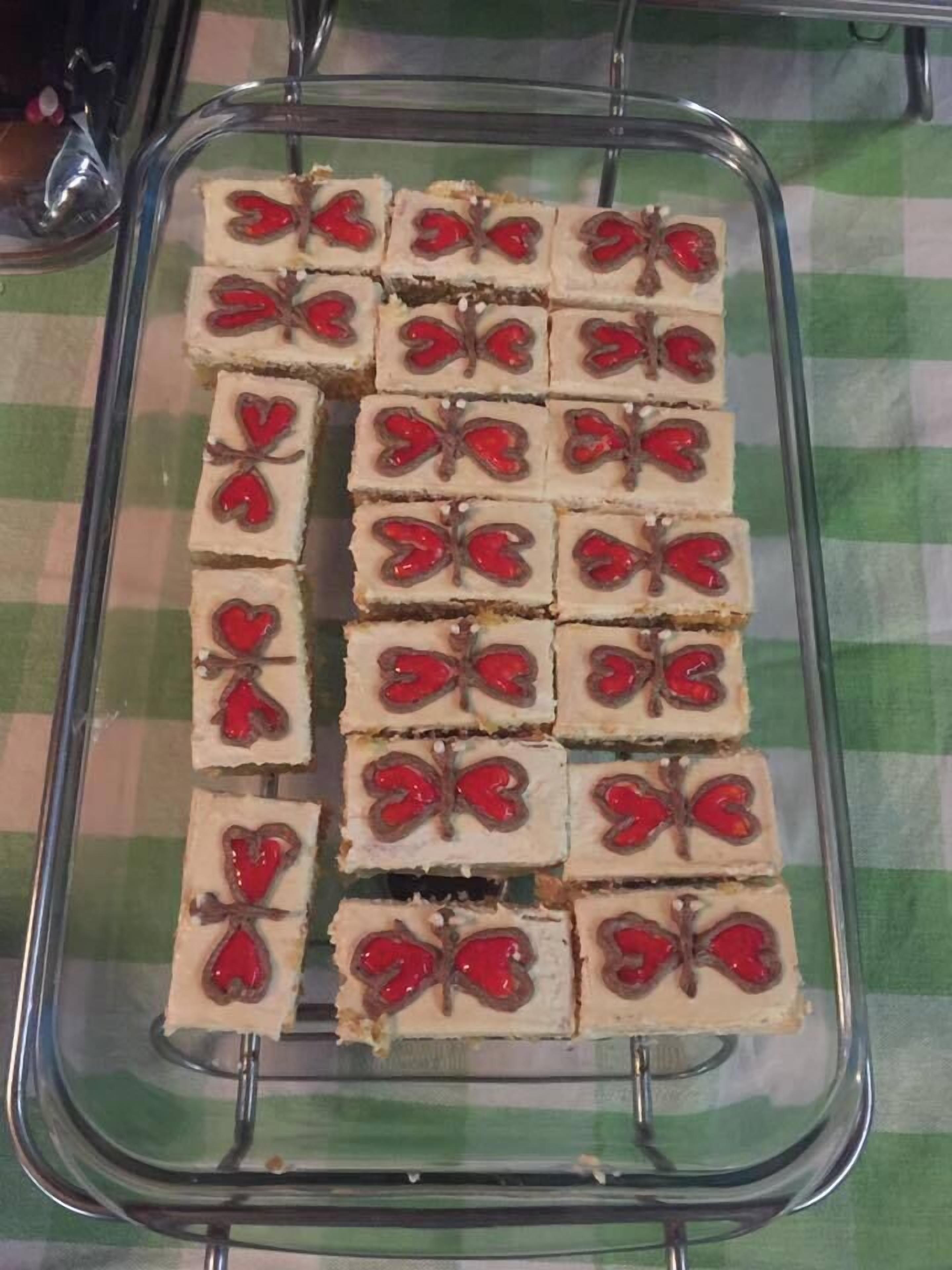 A glass baking dish with heart-shaped desserts arranged in rows.