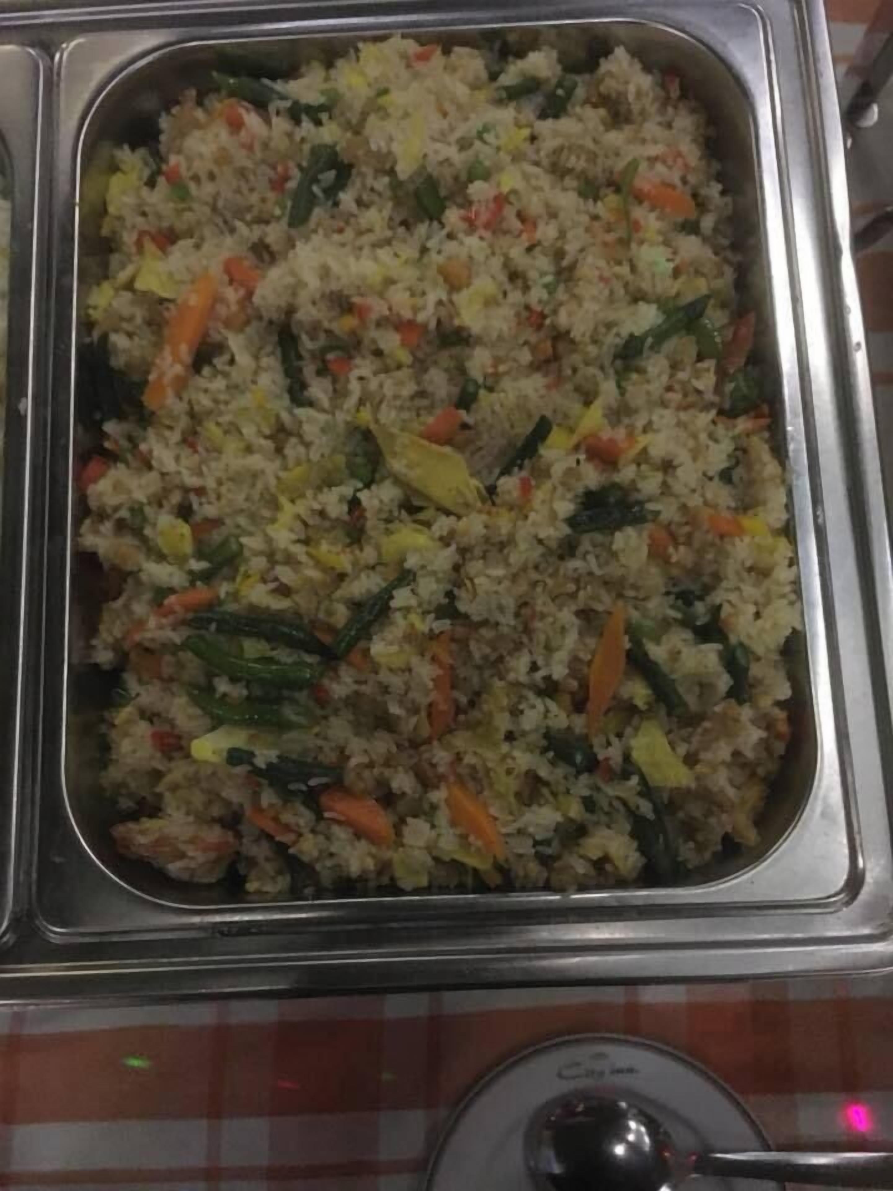 A buffet with a variety of fried rice dishes.