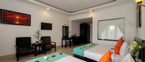 A hotel room with two beds, a desk, a chair, a TV, and a large window.