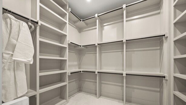 A walk-in closet with open shelving and a hanging rod. - Festive Villa in Richardson/Dallas (Richardson)