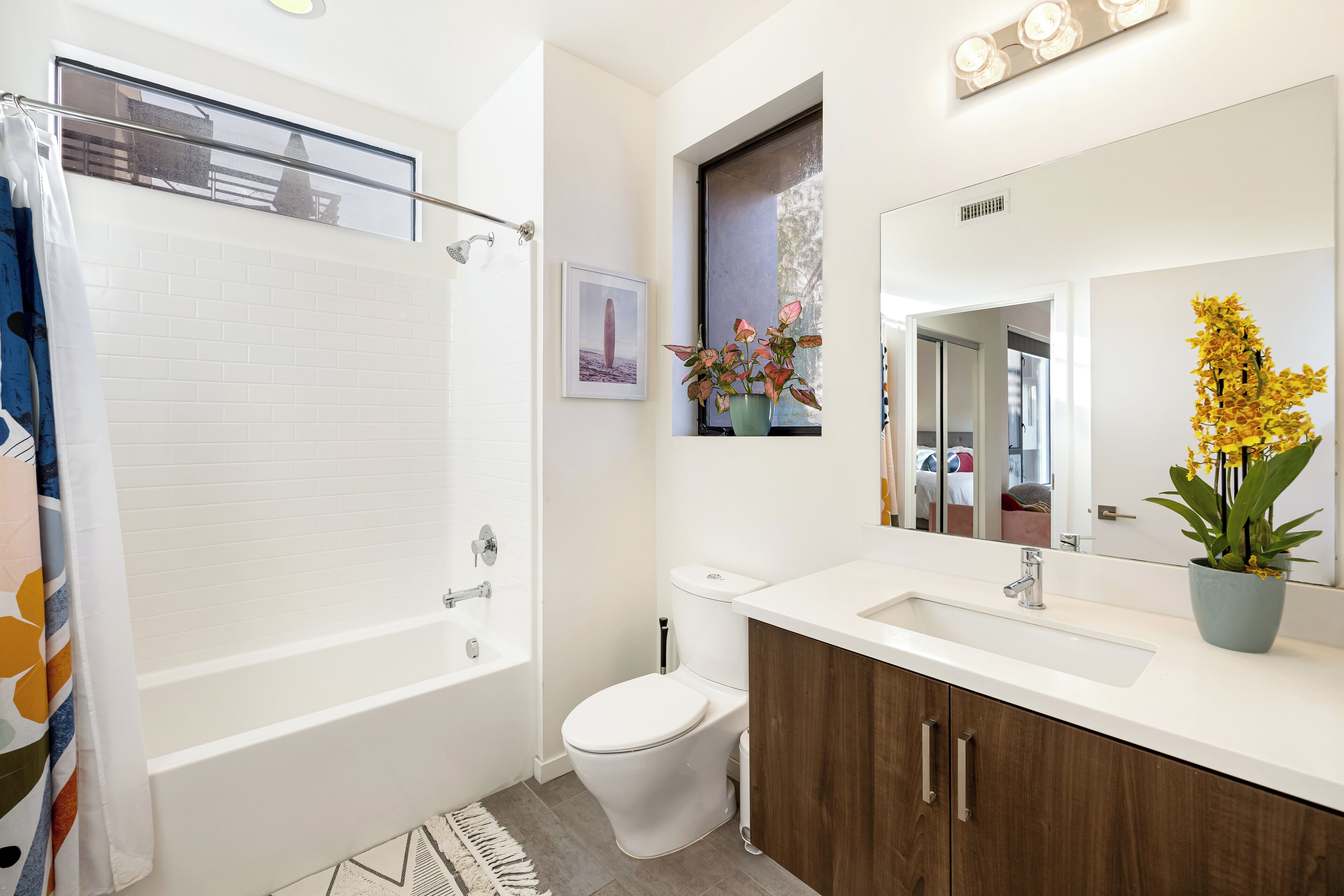 A modern bathroom with a bathtub, toilet, and sink.