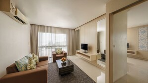 A modern living room with a sofa, coffee table, and TV. - Aspira Petchkasem (Krathum Baen)