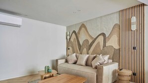 A modern living room with a sofa, coffee table, and decorative items.