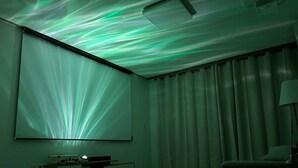 A room with a large projection screen, a desk, a chair, and a lamp. - Ondam Pension (Incheon)