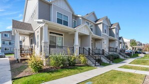A row of modern, two-story townhouses with a covered front porch and a small front yard. - Comfort Stay w/ Studio • Thanksgiving Point (Lehi)