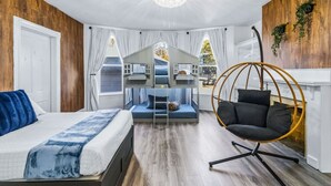 A bedroom with a bunk bed, a hanging chair, and a chandelier. - 6BR Gem in Midtown Atlanta (Atlanta)