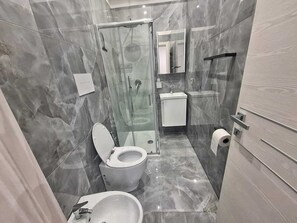 Shower, towels, soap, toilet paper