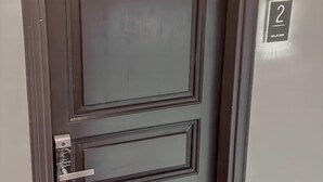A dark brown door with a modern handle and a number "2" sign indicating the room number. - Balatside Family Suite (İstanbul)