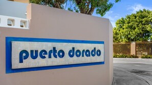 A sign with "puerto dorado" written on it. - Tropical Sunset Penthouse • Rooftop & Hot Tub (Cabo Rojo)