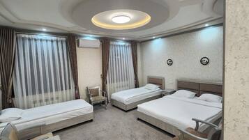 Quadruple Room, Garden View | Minibar, desk, free WiFi, bed sheets