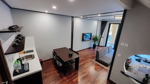 A compact living space with a kitchenette, a dining area, a sofa, and a TV. - Lynntimes Thanh Thuy Wellness Resort (Thanh Thuy)
