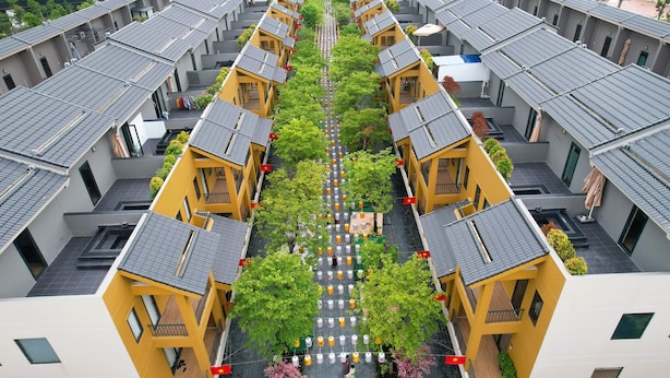 A symmetrical residential building with a central courtyard, featuring uniform balconies and a central walkway. - Lynntimes Thanh Thuy Wellness Resort (Thanh Thuy)