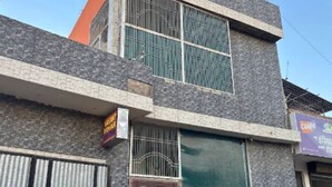 A two-story building with a metal gate and a signboard. - Vasant Vihar Inn (Ayodhya)