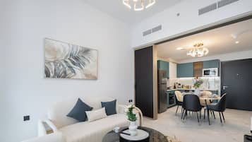 Luxury Apartment, Balcony, City View | Living area | 65-inch Smart TV with satellite channels