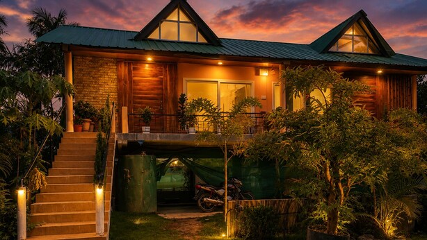 A two-story wooden house with a covered driveway, a staircase, and a well-maintained garden. - Lemon wood Cottage (Naobaricha)