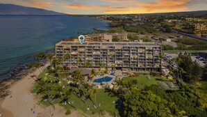 Ein großes Hotel mit mehreren Etagen, einem Pool und einer Strandanlage.