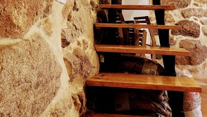 A wooden staircase with stone walls, a clock, and a wooden ceiling. - Charming Tourém Retreat 3 Bedroom House With Stunning Views (Montalegre)